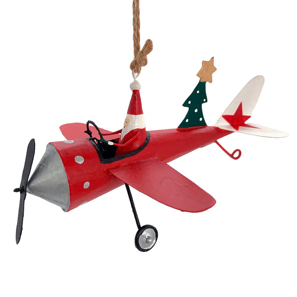Babbo natale in aereoplano rosso con albero