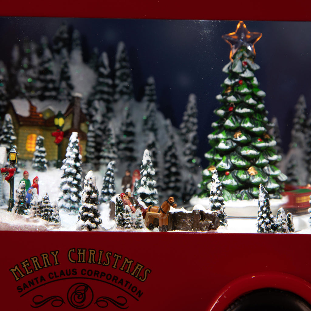 Camion natalizio musicale e luminoso con villaggio innevato